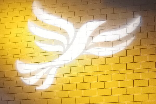 Lib Dem logo bird projected on blockwork